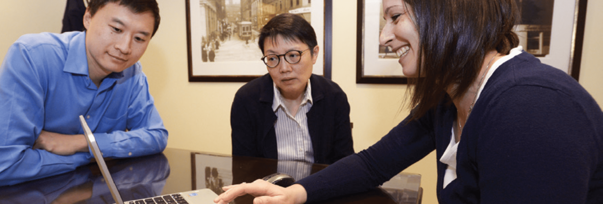 Funeral preplanner meeting with clients, reviewing arrangements on a laptop. Funeral preplanner meeting with clients, reviewing arrangements on a laptop.